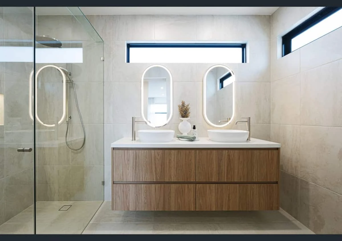 Contemporary bathroom with double vanity and curved mirrors