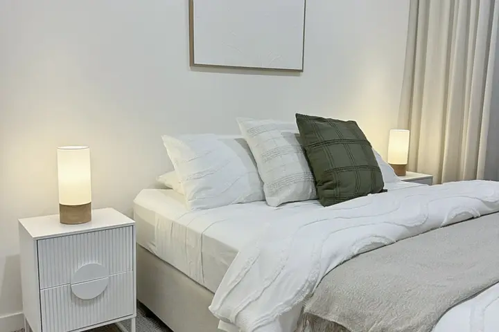 Master suite with a king bed, soft linen and bedside lamps