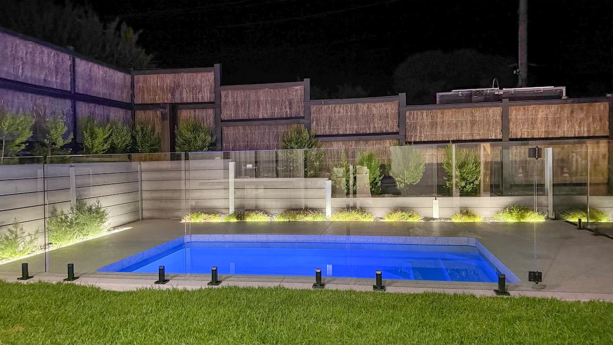 The illuminated private swimming pool and garden at Casa al Mare in the evening